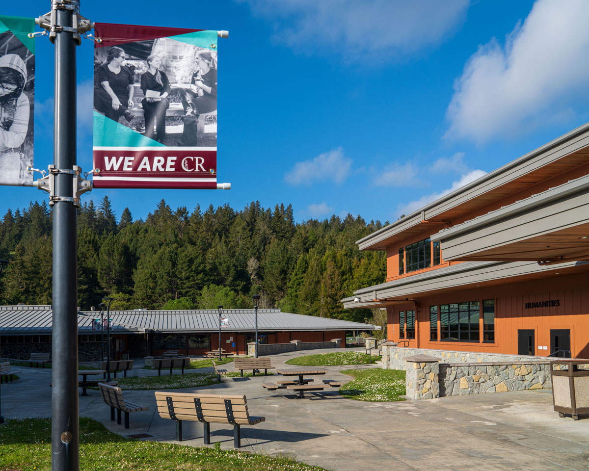 campus building with We Are CR flag pole sign